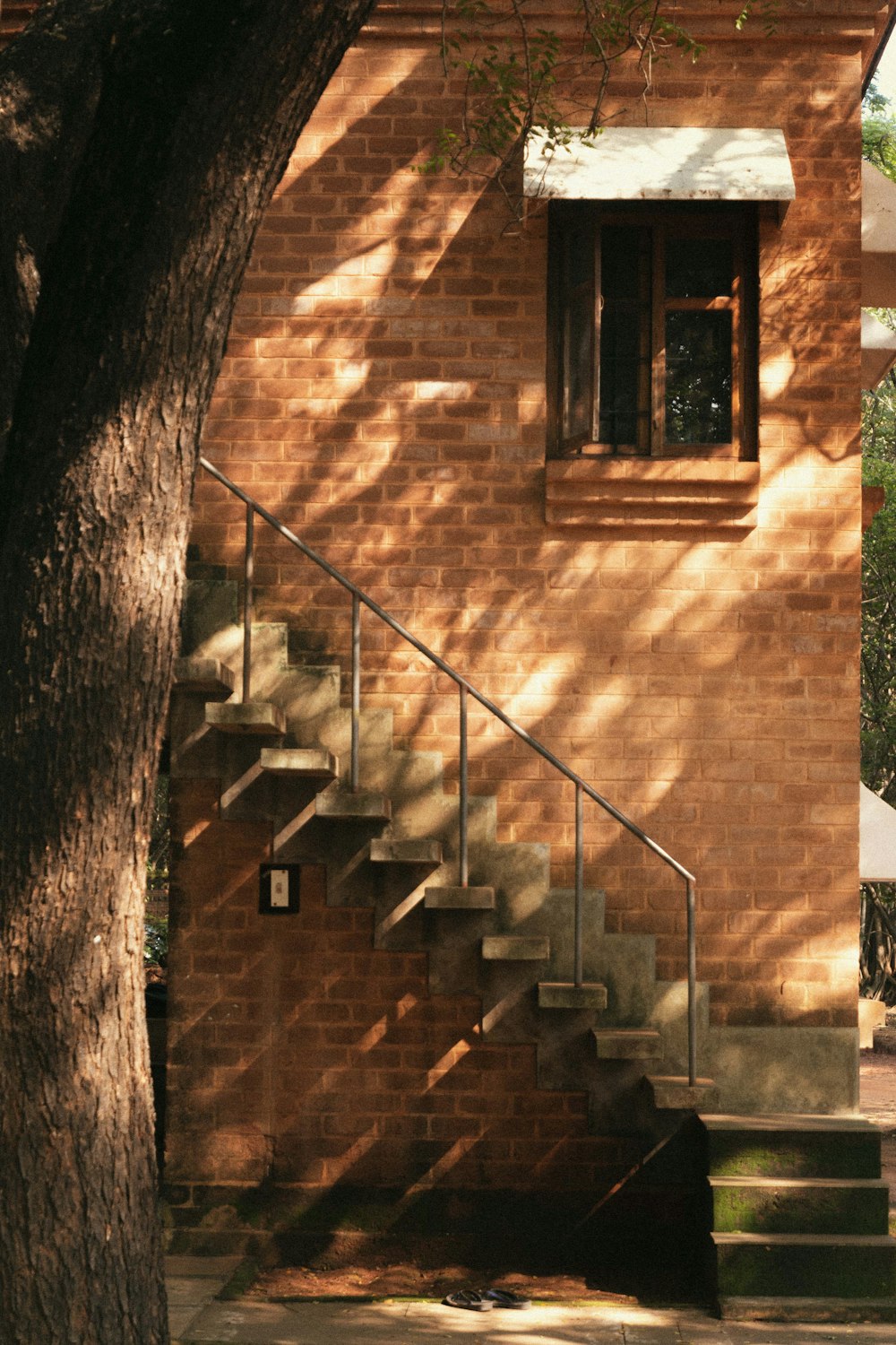 a brick building with a tree in front of it