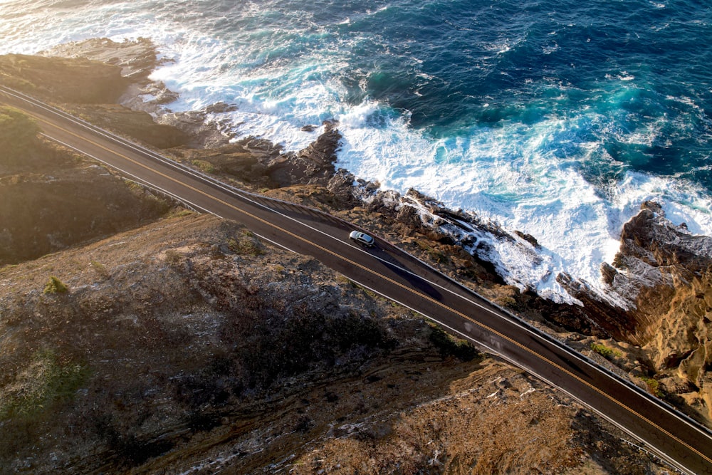 an aerial view of a highway near the ocean