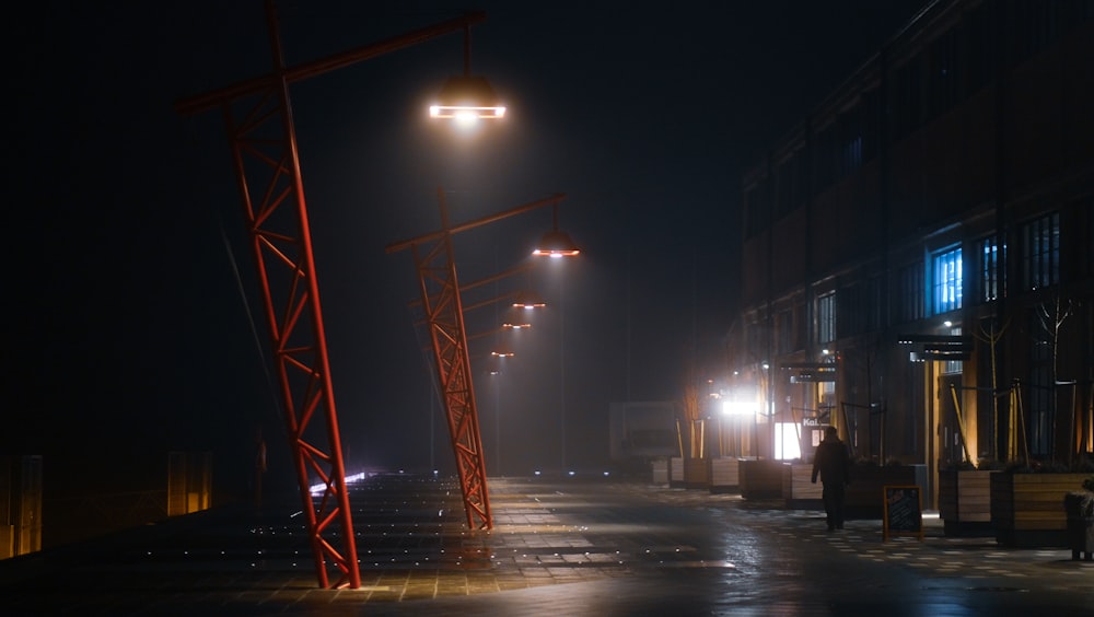 a person walking down a street at night