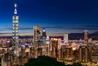 The bustling urban skyline of Mexico City framed by deep blue evening sky.