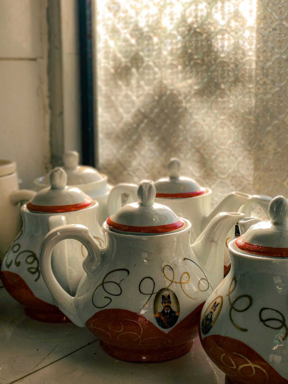 a group of teapots sitting on top of a counter