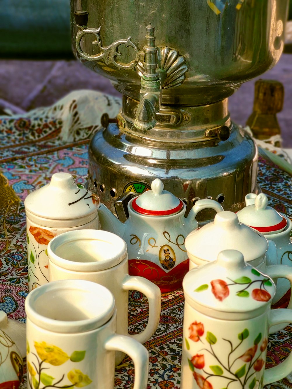 a table topped with cups and a tea pot