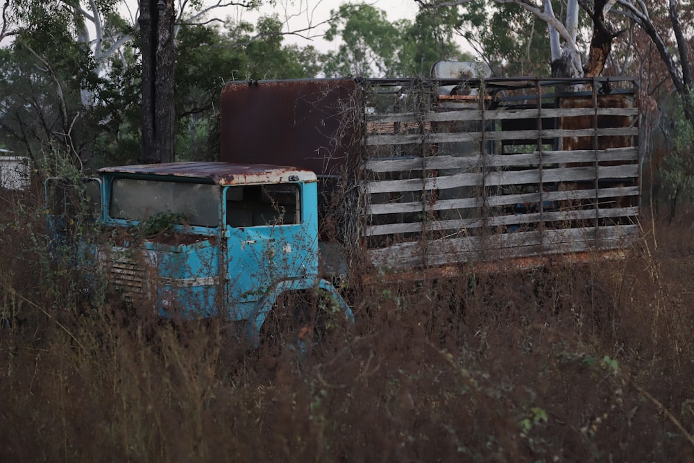 an old truck is sitting in a field