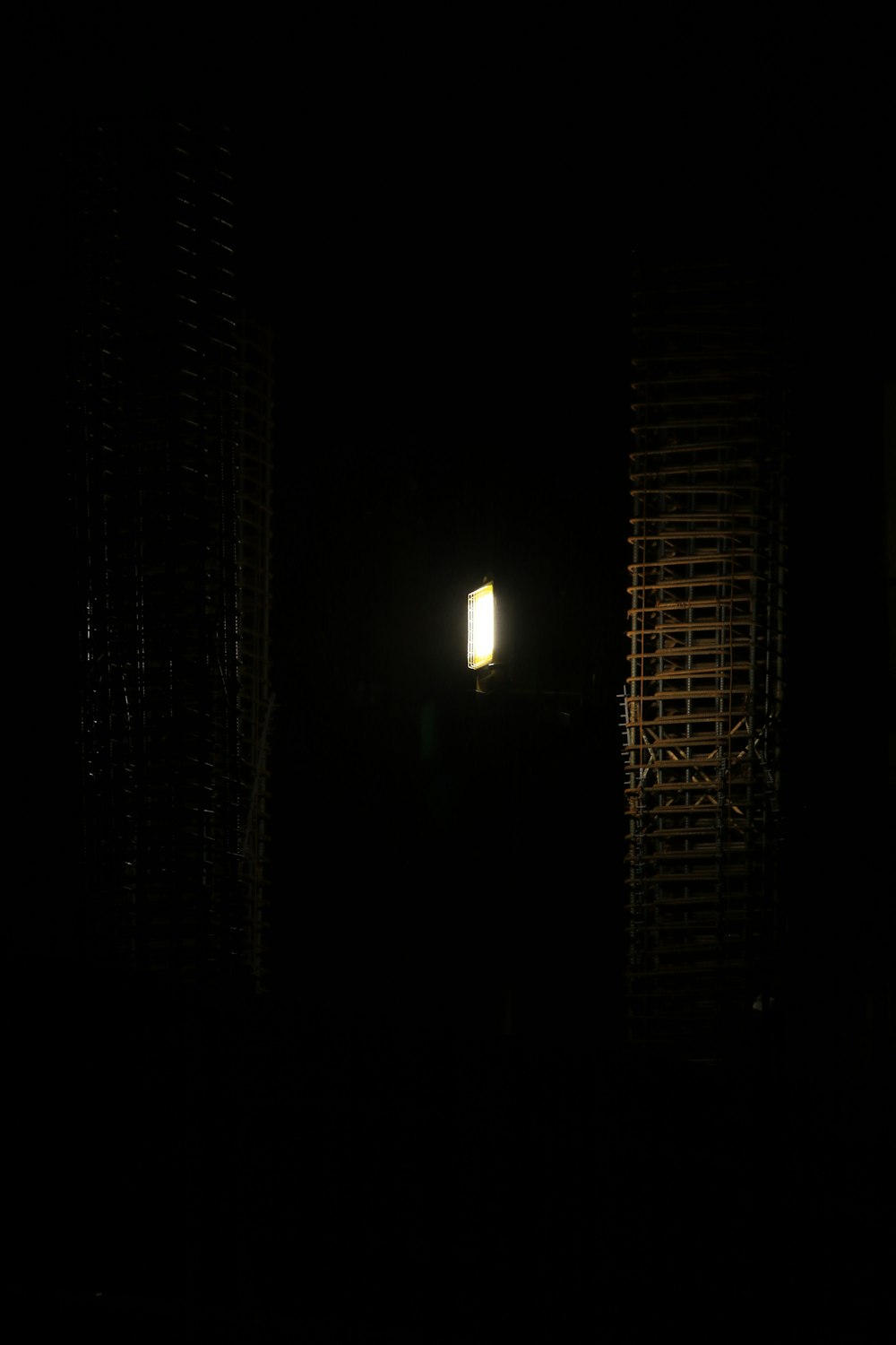 a dark room with a window and a street light