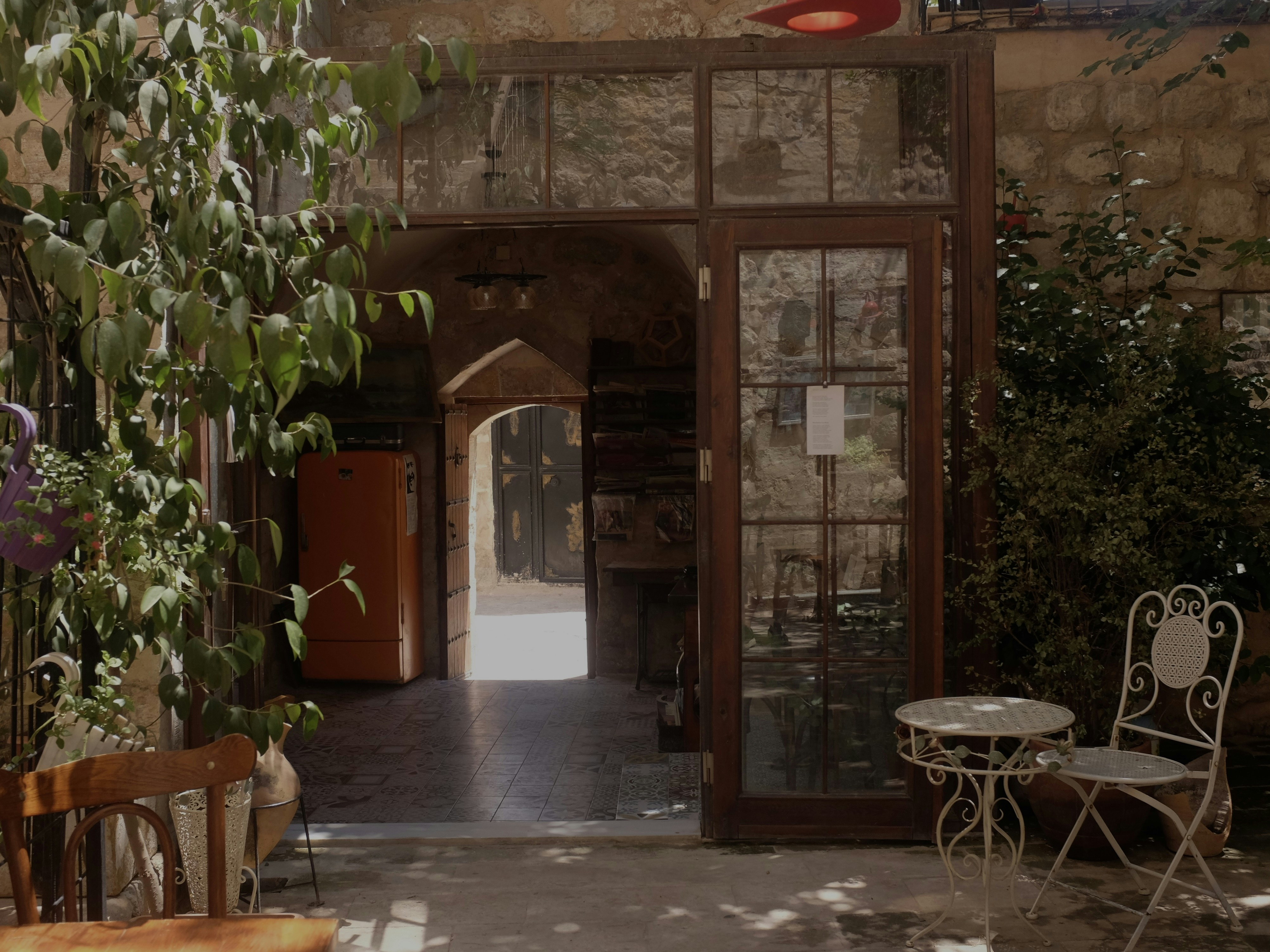 A table and chairs in a room with stone walls