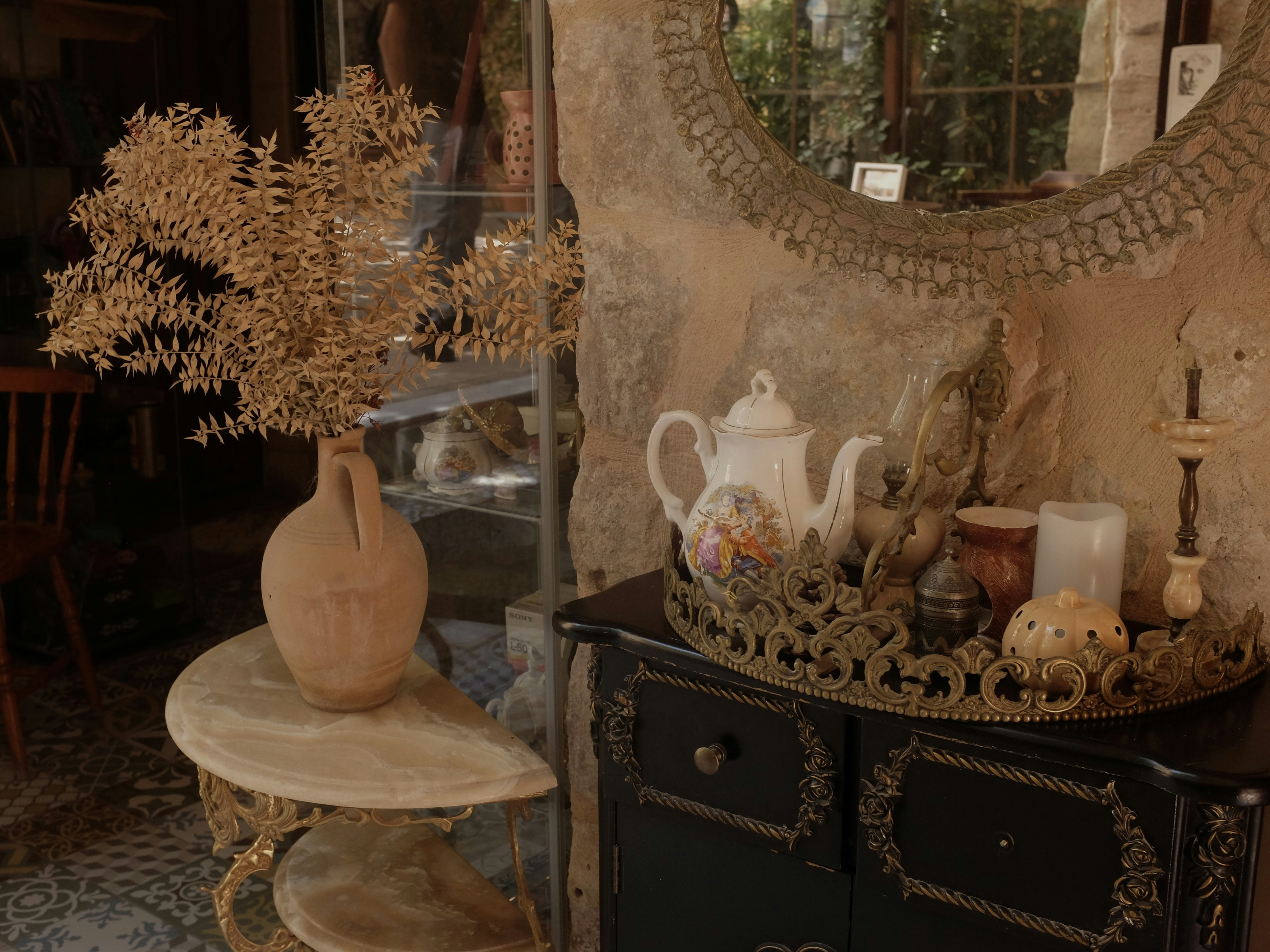 a table with a vase and a mirror on it