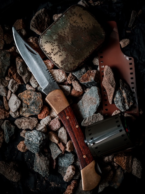 a knife and some rocks on the ground