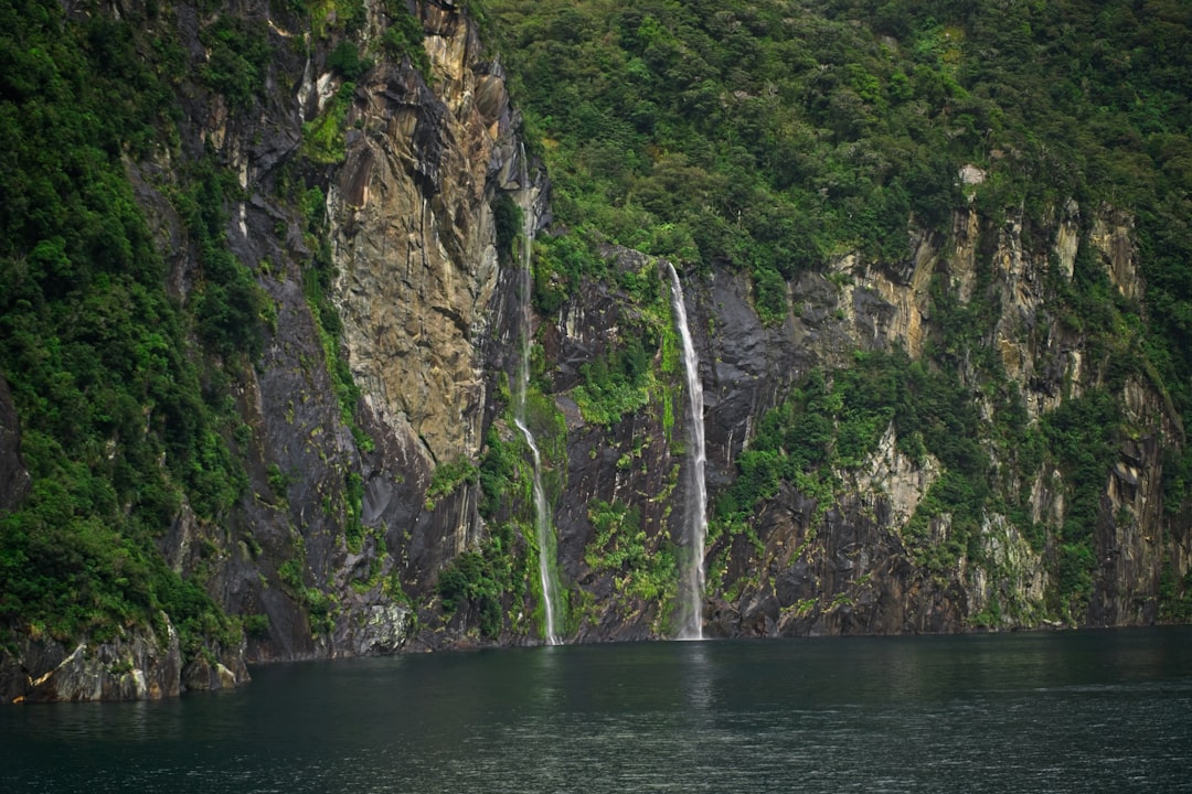 a waterfall in the middle of a body of water,