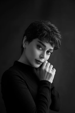 a woman posing for a black and white photo