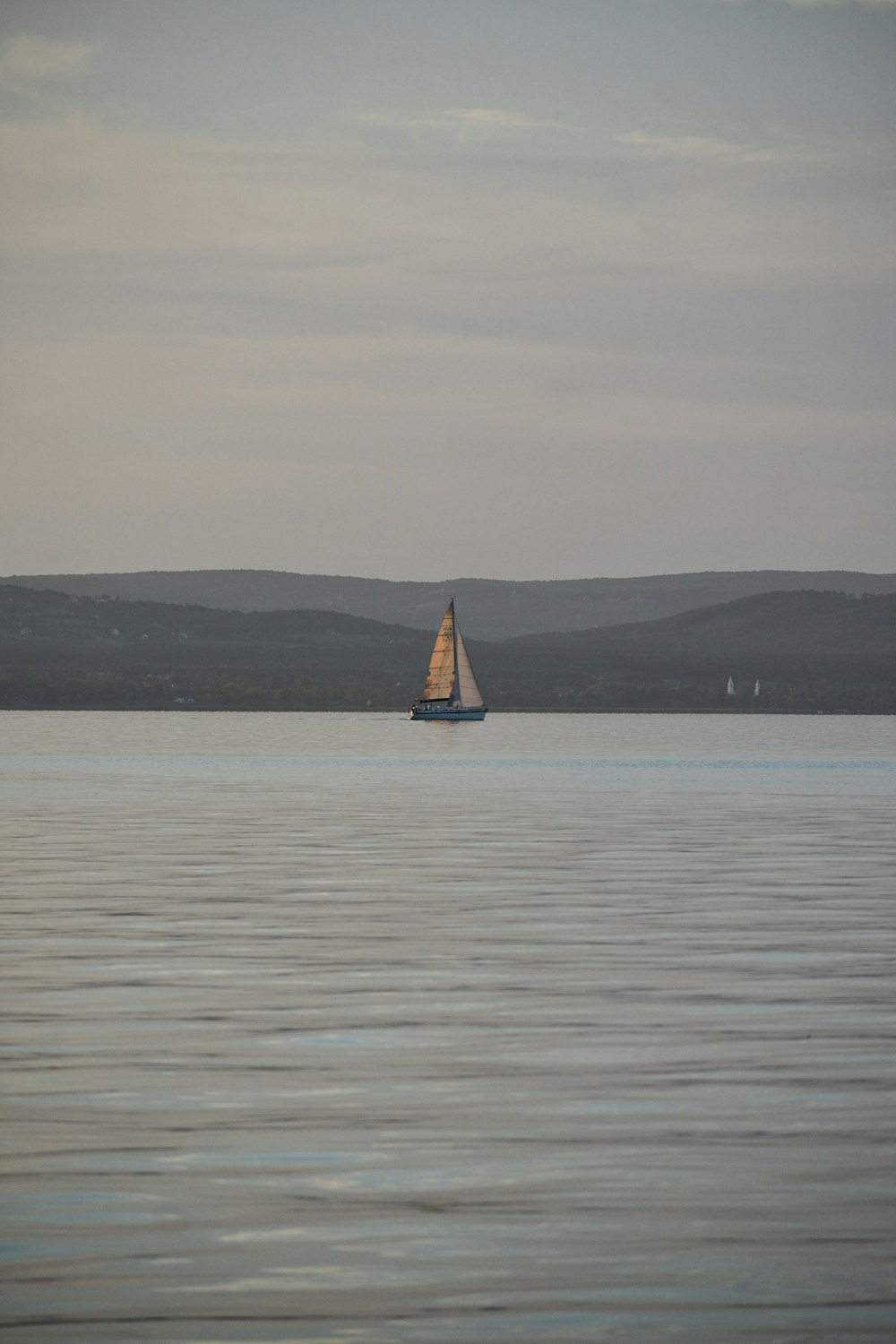 a sailboat sailing on a large body of water