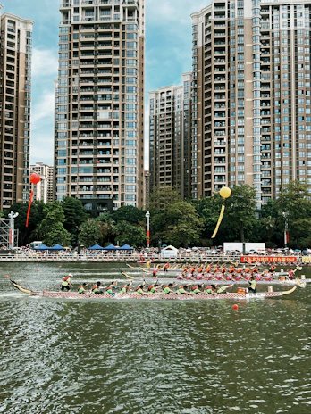 A dynamic shot capturing a dragon boat team mid-race, water splashing energetically around their synchronized paddles.