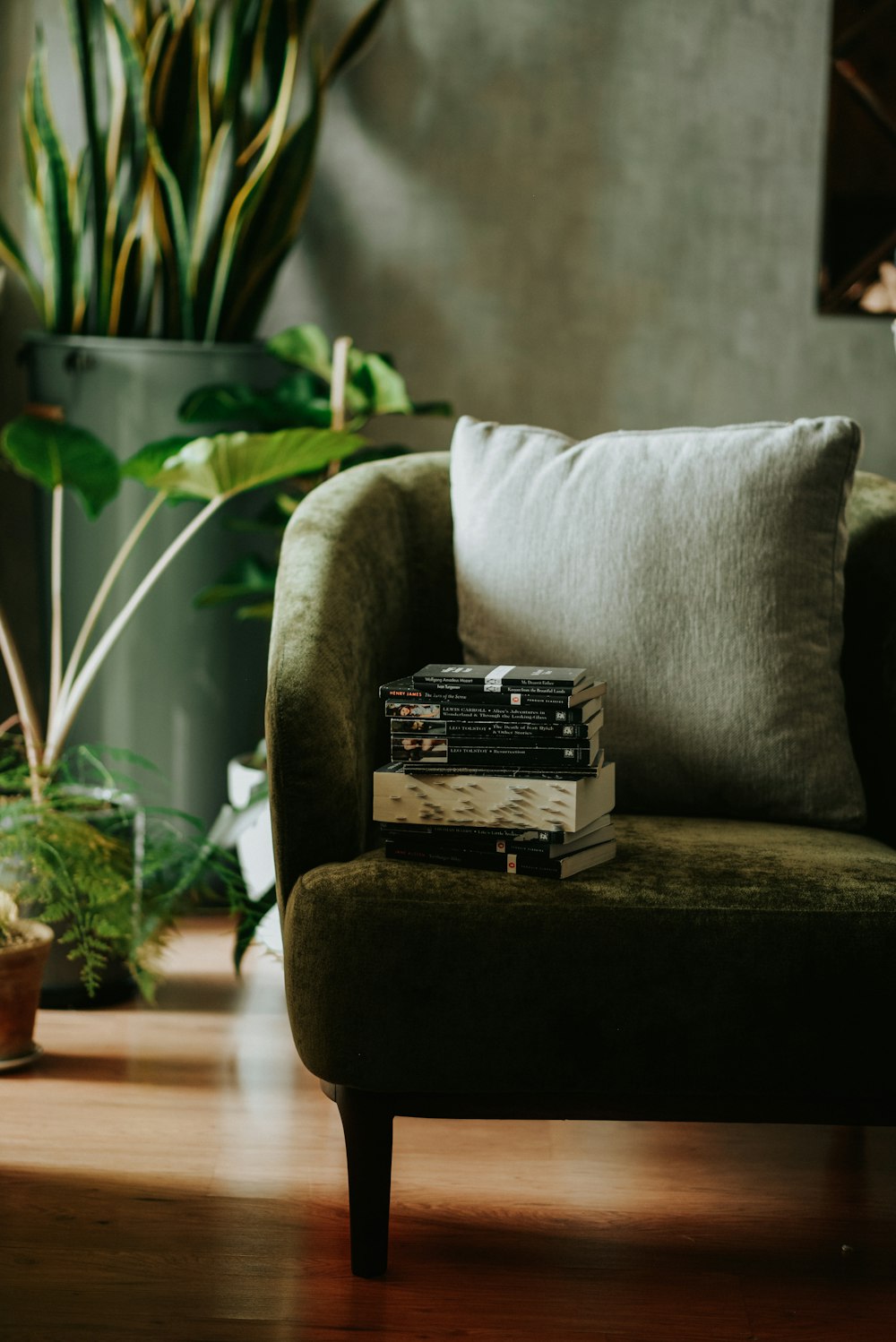 a stack of books sitting on top of a green chair