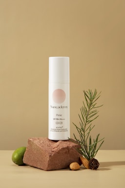 a bottle of deodorant sitting on top of a rock next to a