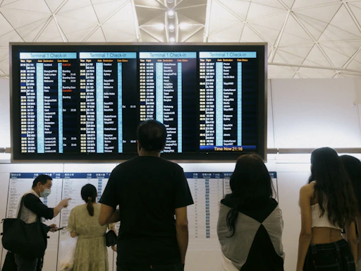 a group of people standing in front of a large screen