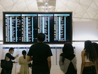 a group of people standing in front of a large screen