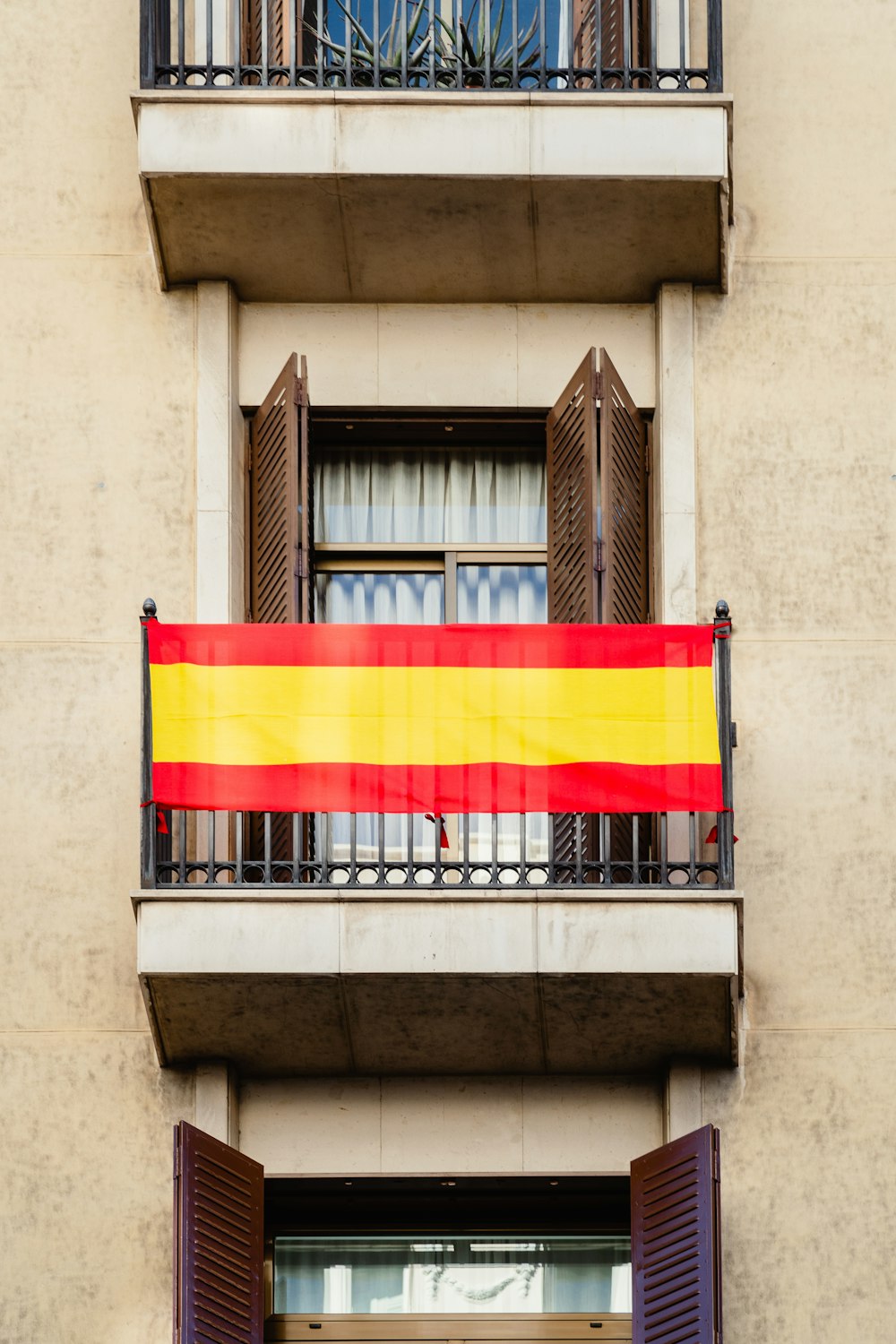 a balcony with a flag hanging from it