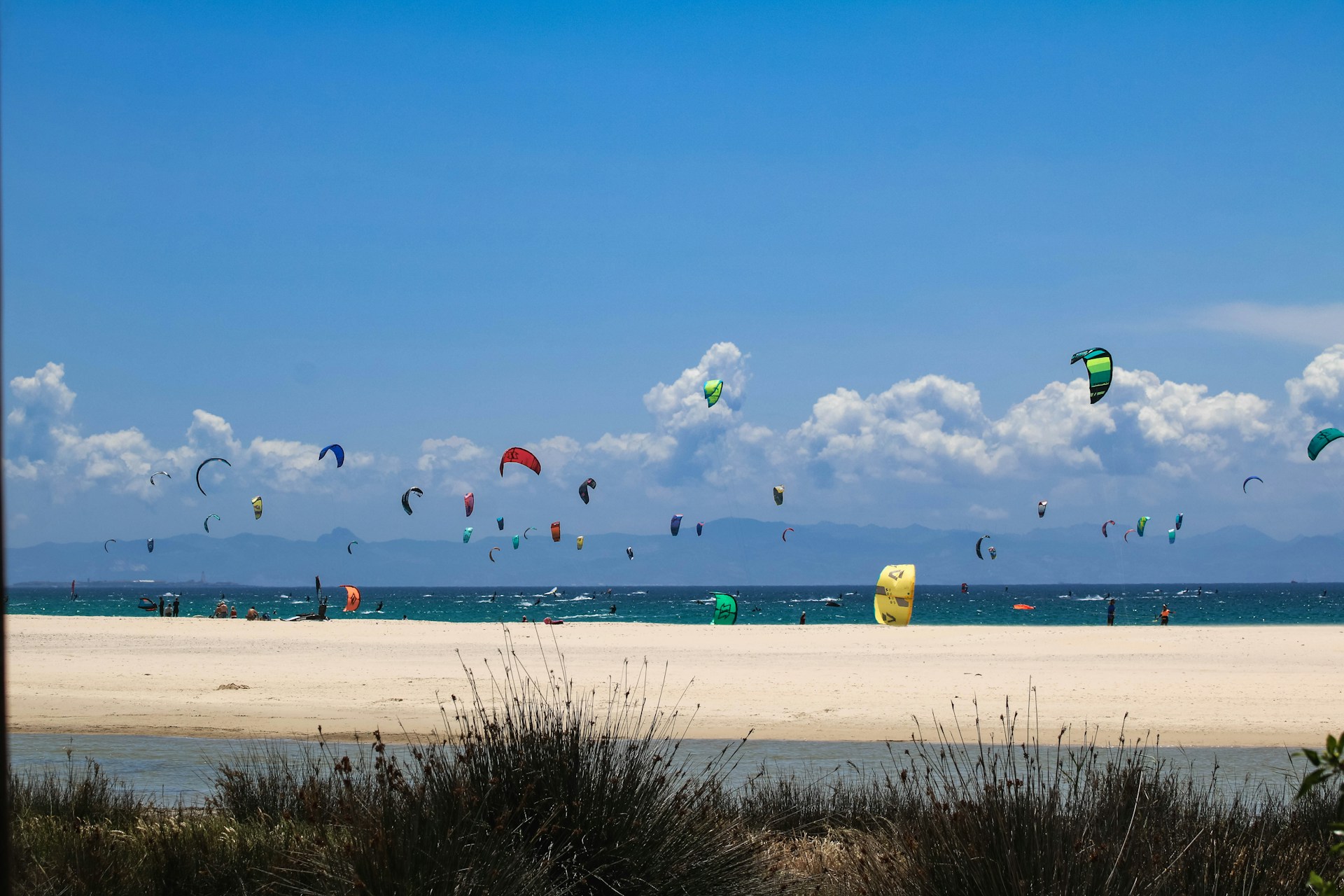 woman wearing yellow long-sleeved dress under white clouds and blue sky during daytime