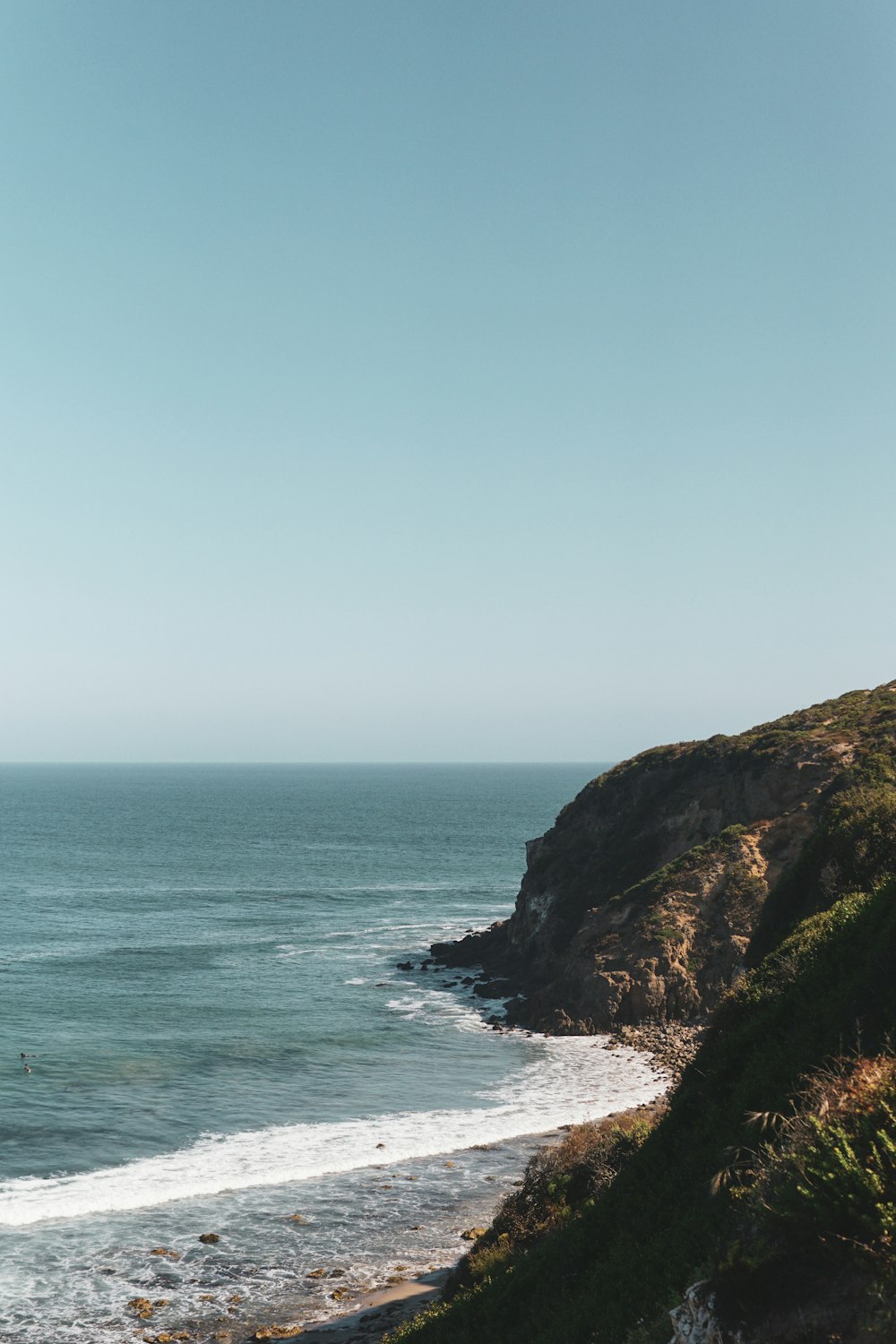 a view of the ocean from the top of a hill