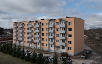 an apartment building with cars parked in front of it