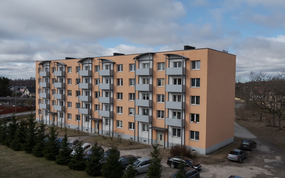 an apartment building with cars parked in front of it