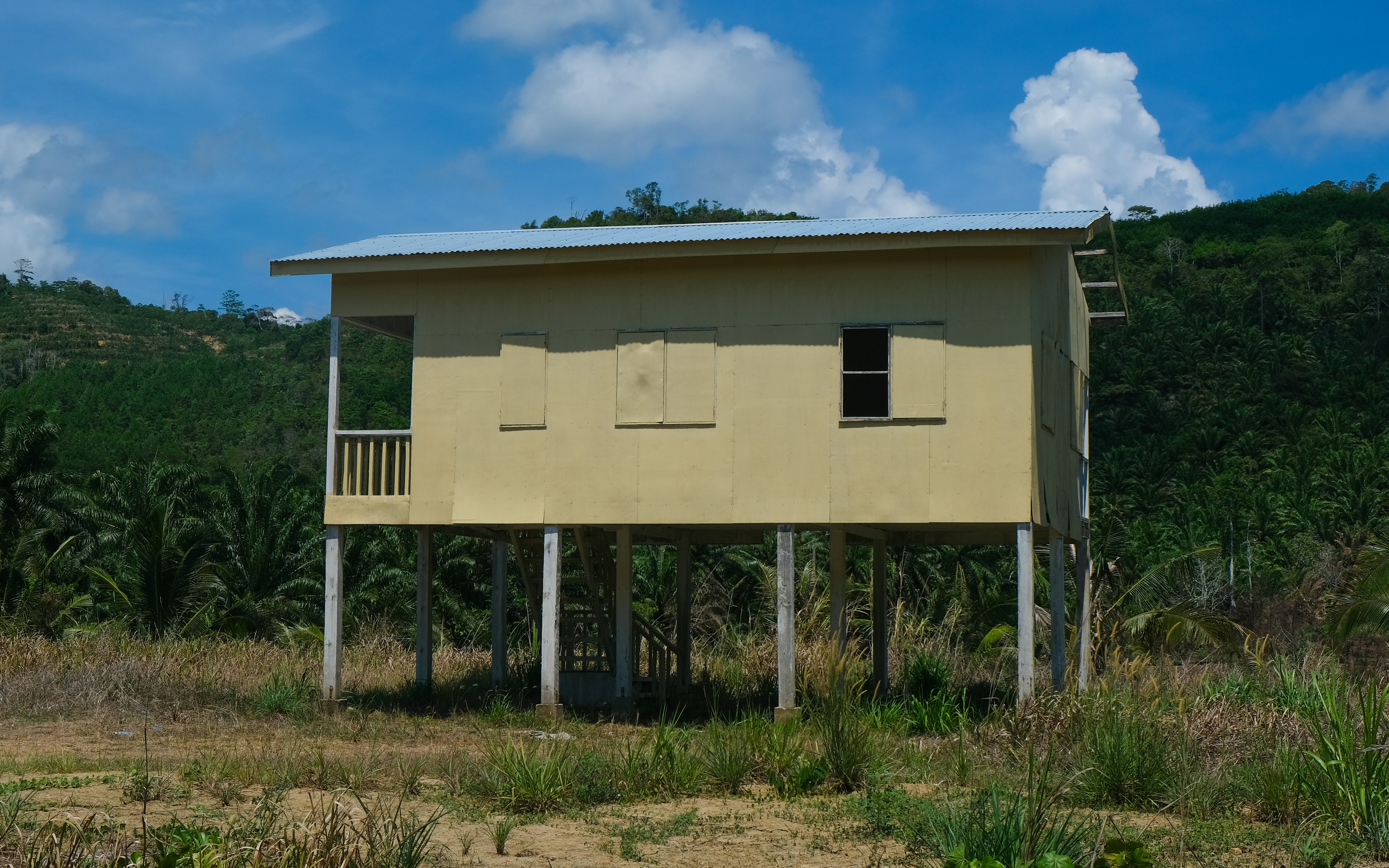 a yellow building with a balcony on top of it