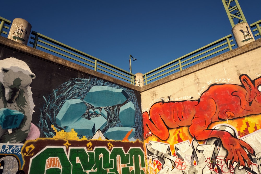 a wall covered in lots of different colored graffiti