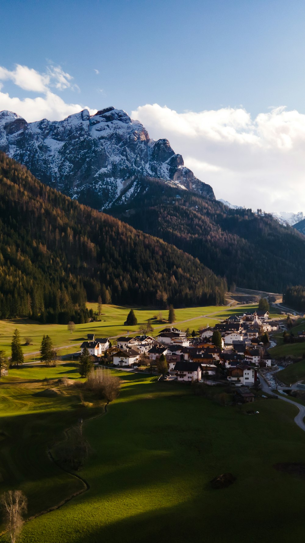 a scenic view of a village in the mountains