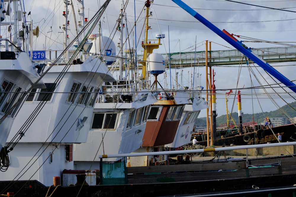 a large white boat sitting next to a dock