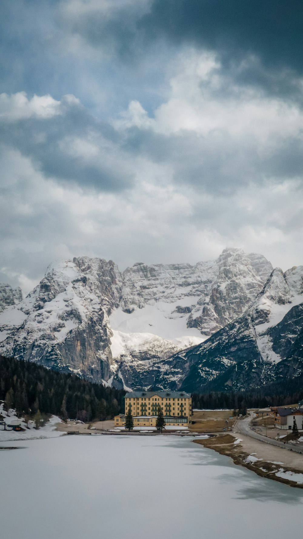 a large body of water surrounded by snow covered mountains