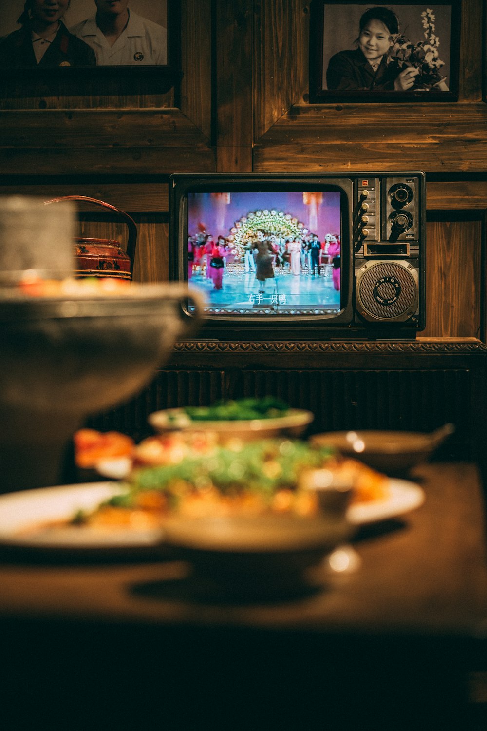 a table topped with plates of food and a tv