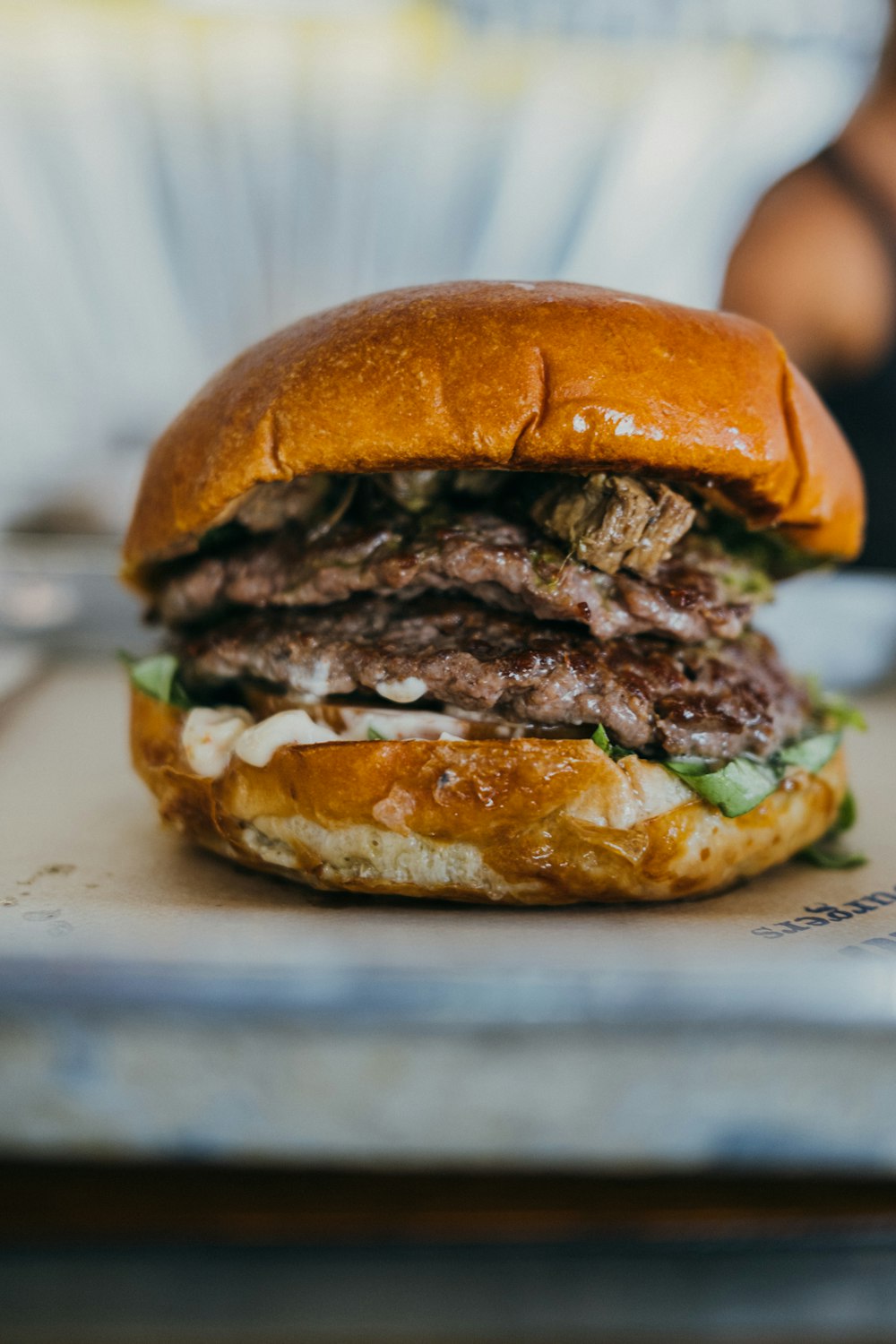 a close up of a hamburger on a tray