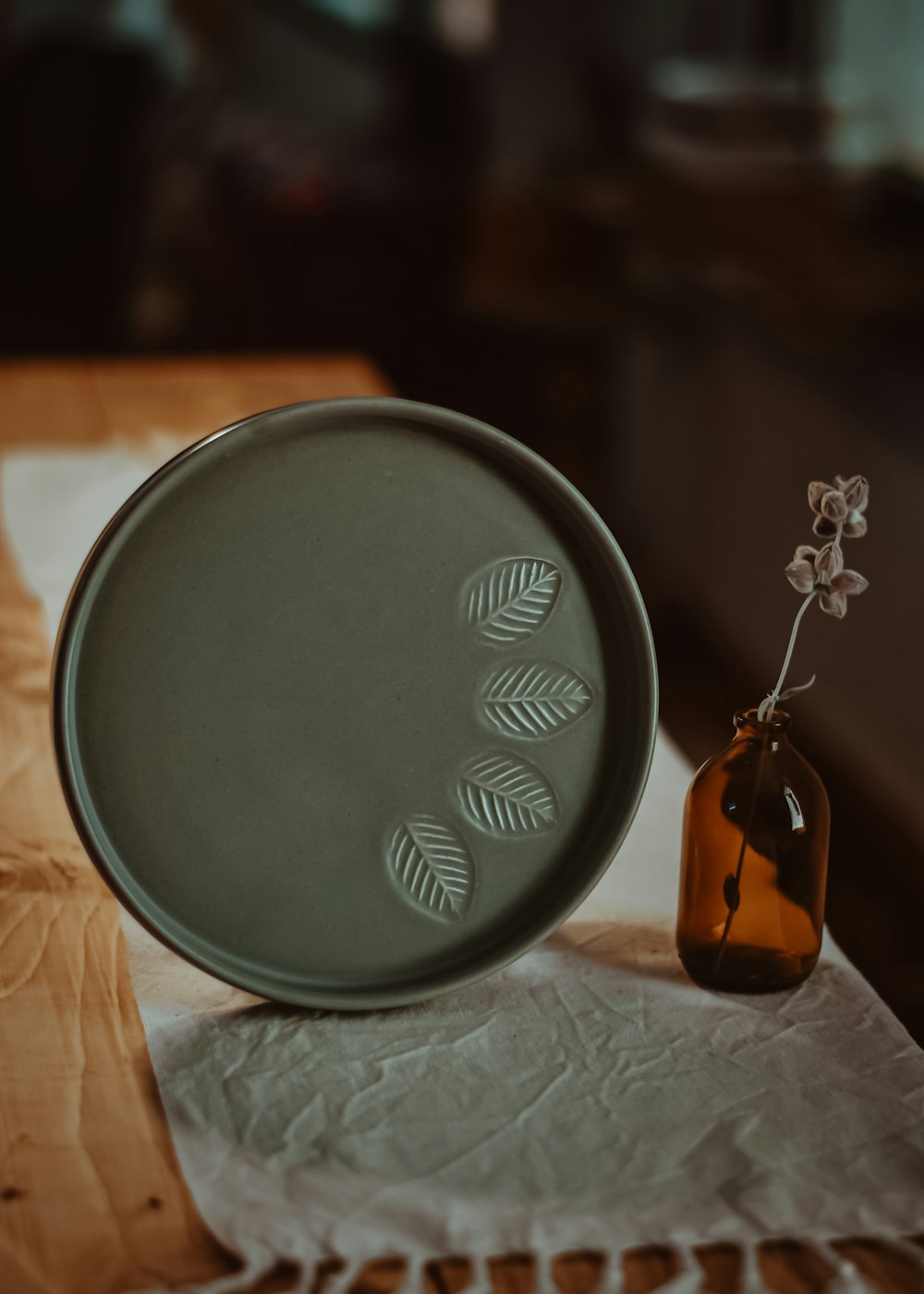 a green plate sitting on top of a wooden table