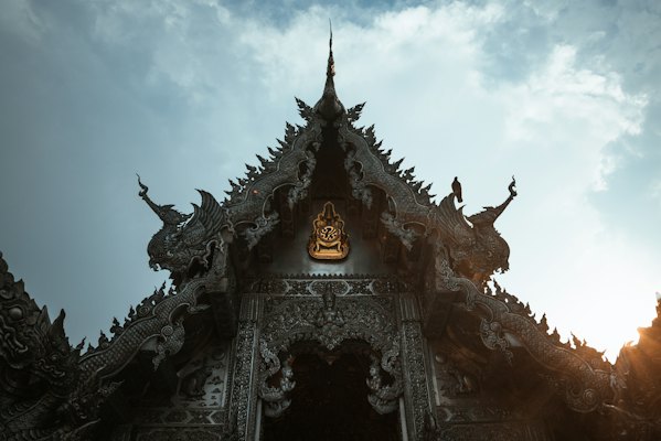 A building that has a statue on top of it — Chiang Mai, Thailand