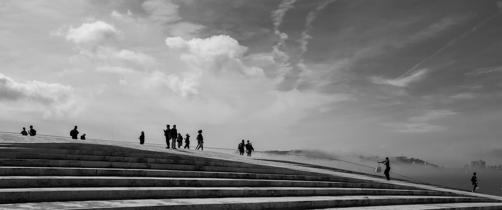 a group of people standing on top of a set of stairs