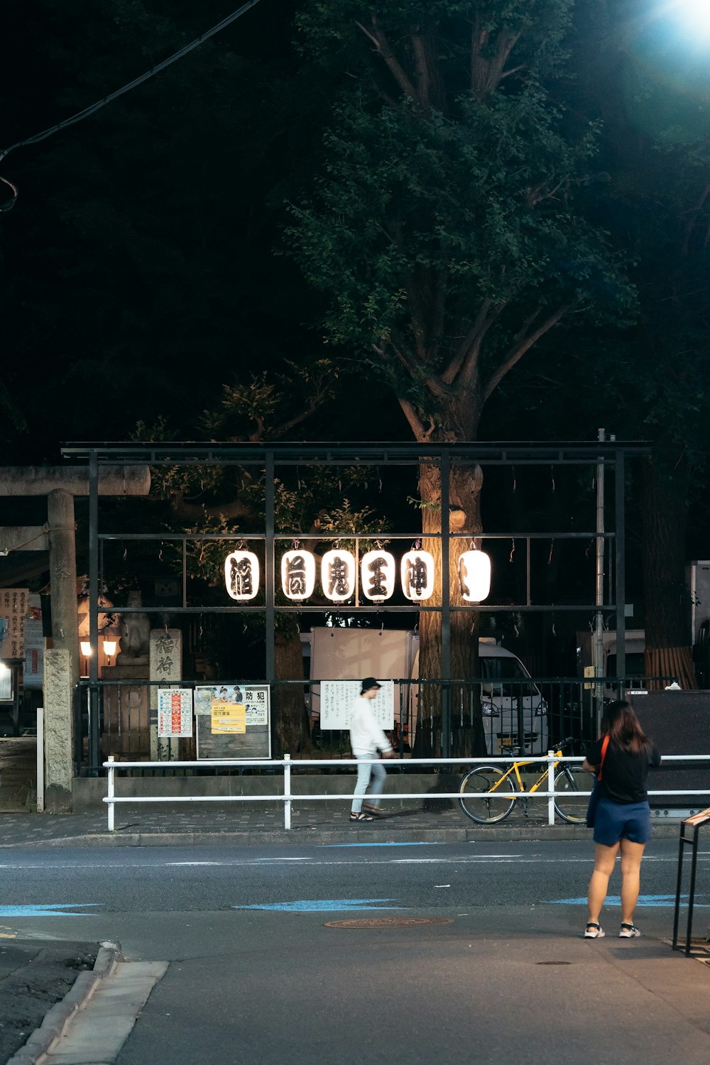 a person walking down a street at night