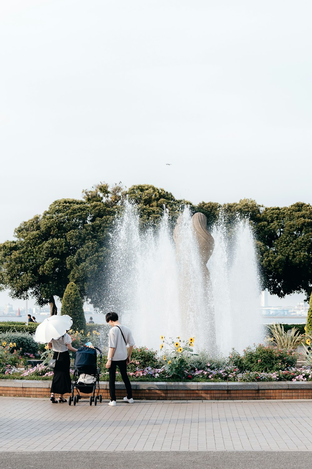 a couple of people standing in front of a fountain