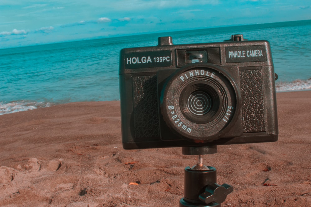 a camera sitting on top of a tripod on a beach