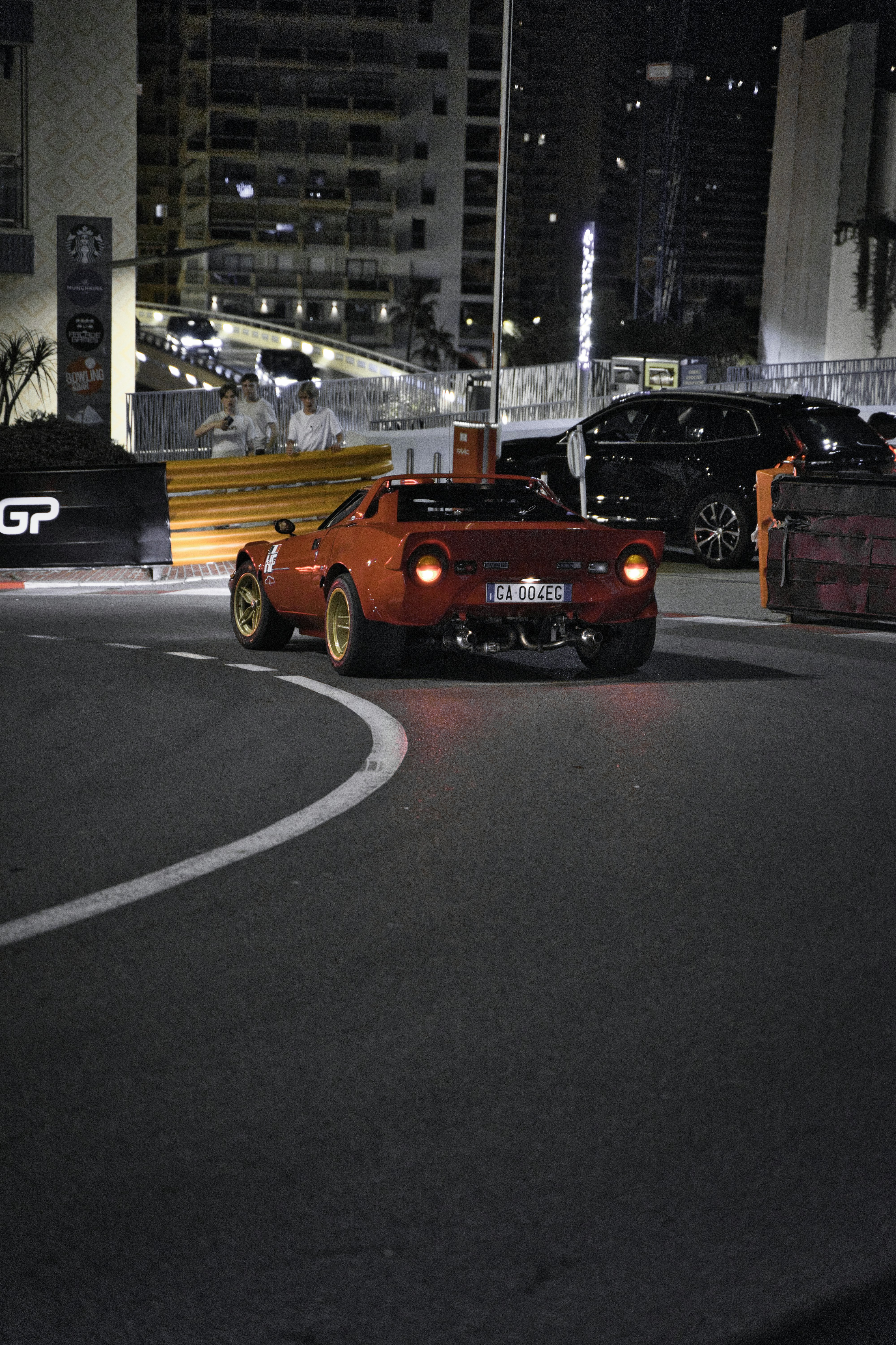 a car driving down a street at night