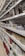 Shelves filled with a variety of kitchenware, including metal colanders, bowls, and stacks of ceramic plates in different colors and patterns.