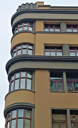 Modern architectural project under construction with warm gray and mustard yellow accents.