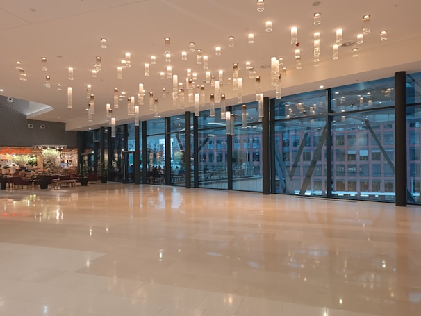 Elegant showroom interior with high-end acoustic and digital pianos displayed under soft lighting.
