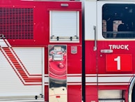 Close-up of a brightly painted electric fire truck car with realistic details.