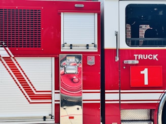 A close-up of a bright red mobile fire pump with the firemodular.com logo on its side.