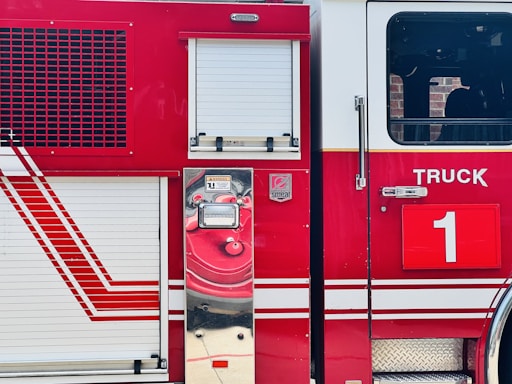 A close-up of a bright red mobile fire pump with the firemodular.com logo on its side.