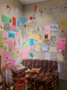 A warm and inviting therapy room with colorful children's drawings on the walls.