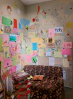 A warm and inviting therapy room with colorful children's drawings on the walls.
