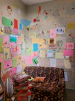 A warm and inviting therapy room with colorful children's drawings on the walls.