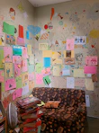 A warm and inviting therapy room with colorful children's drawings on the walls.