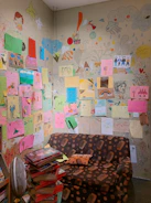 A cozy hospital room decorated with colorful children's drawings and toys.