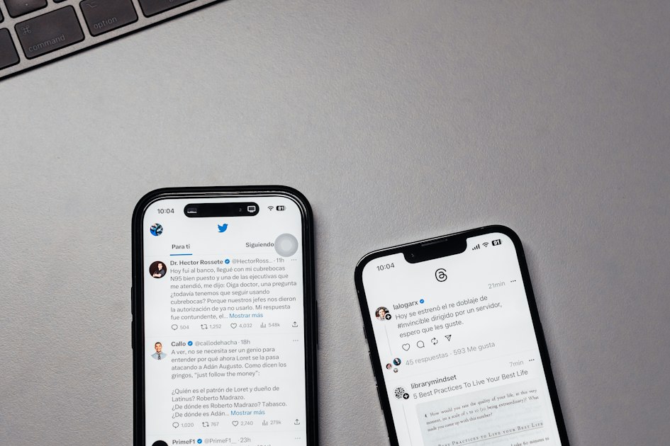 Two iPhones side by side on a table, one displaying Threads and the other Twitter X, illustrating the social platform landscape founders navigate